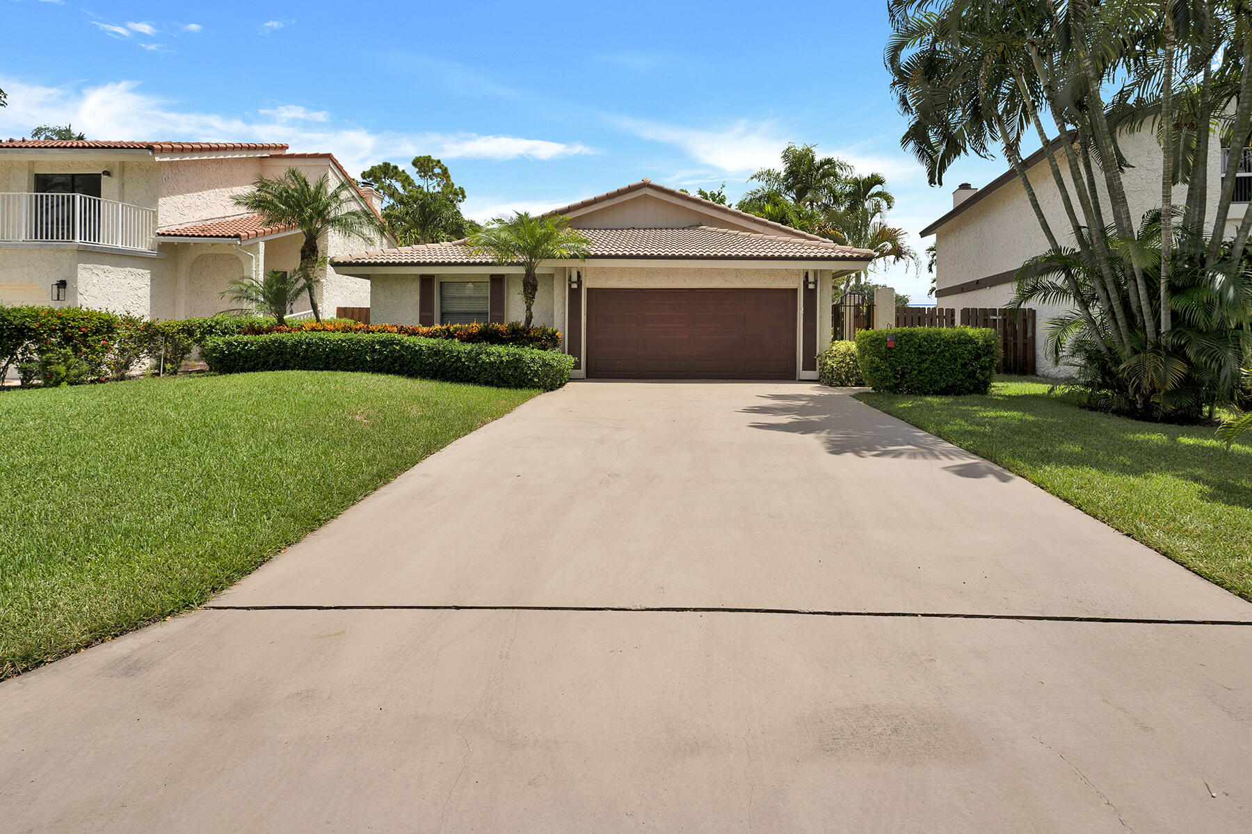 a front view of a house with a garden and yard