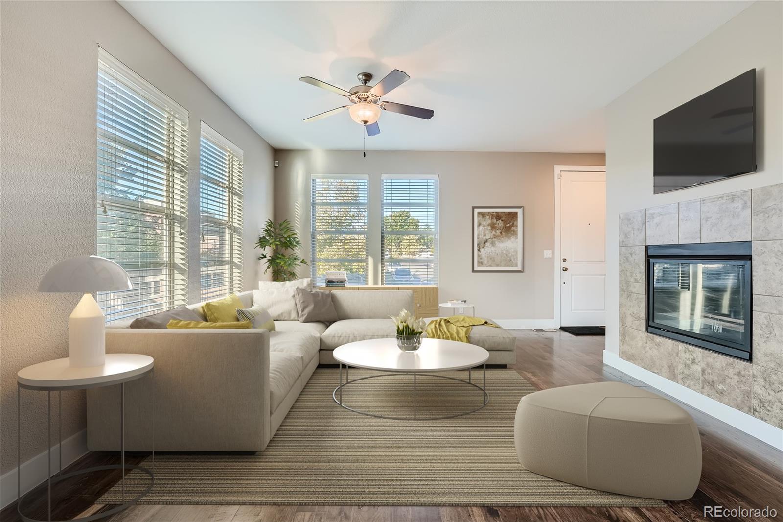 a living room with fireplace furniture and a flat screen tv