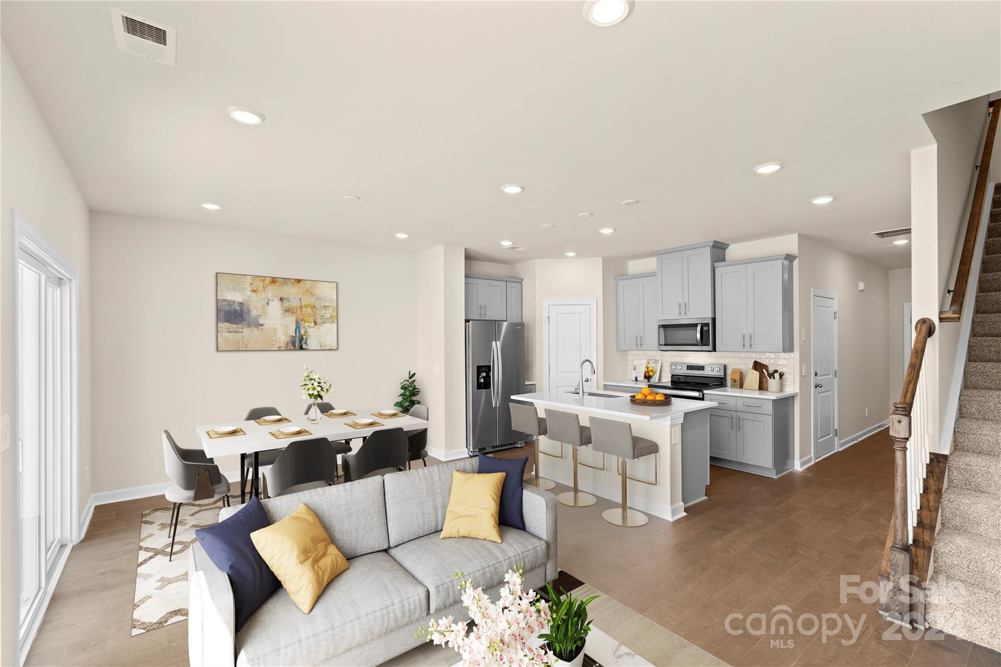 a living room with furniture and kitchen view