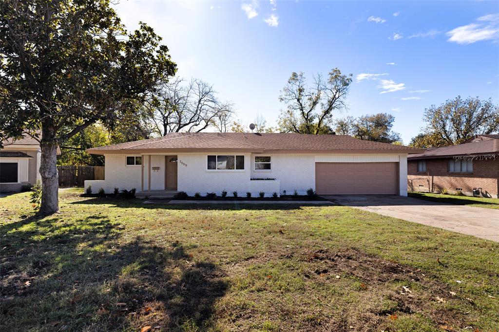 a view of a house with a yard and garage