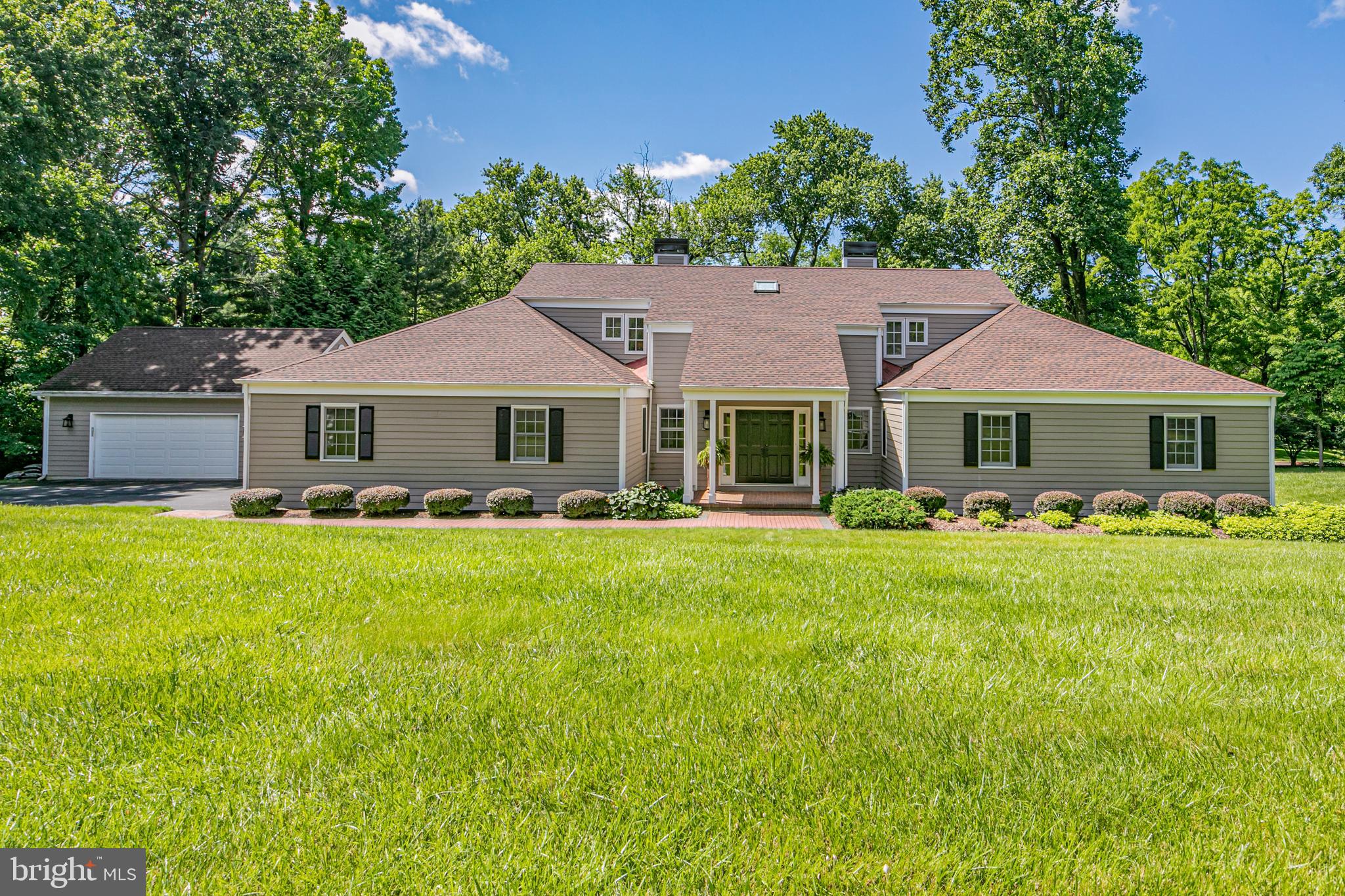 a front view of a house with a garden and porch