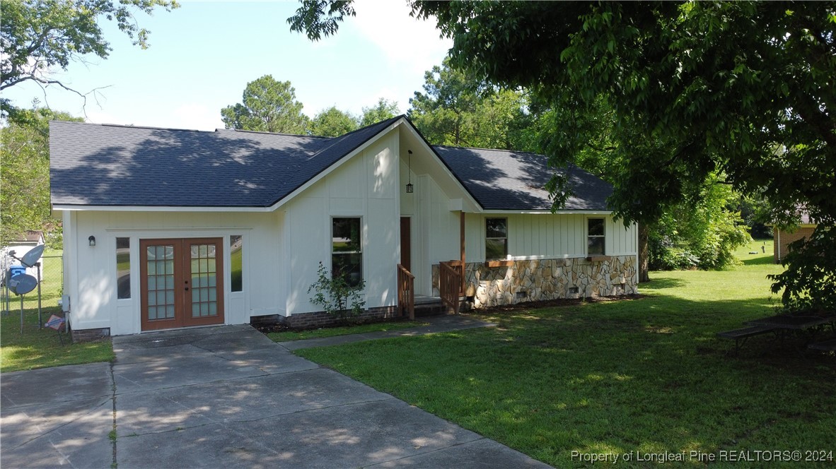 a front view of house with yard and green space