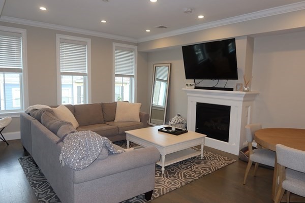 a living room with fireplace furniture and a flat screen tv