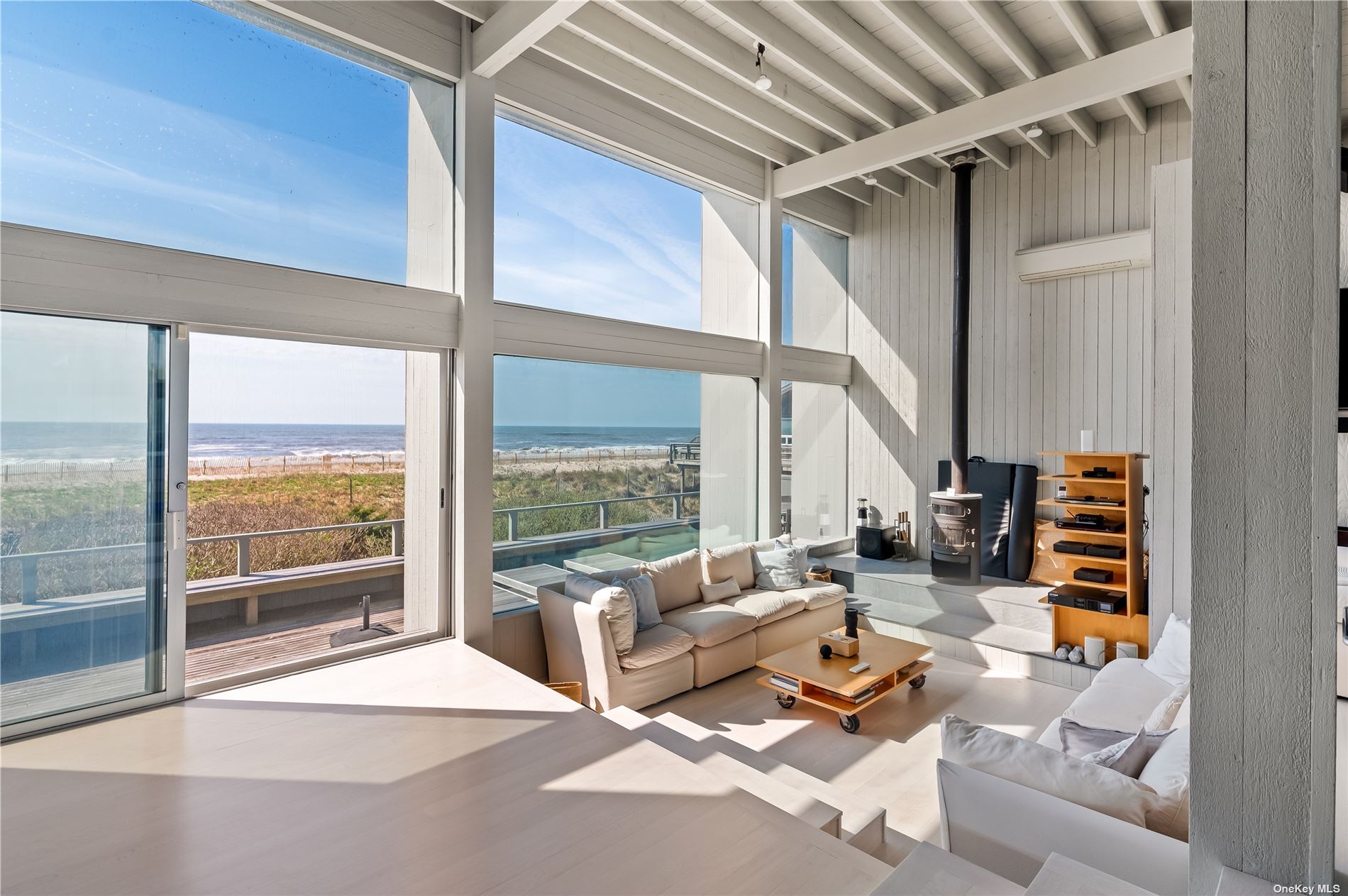 a living room with furniture and a floor to ceiling window