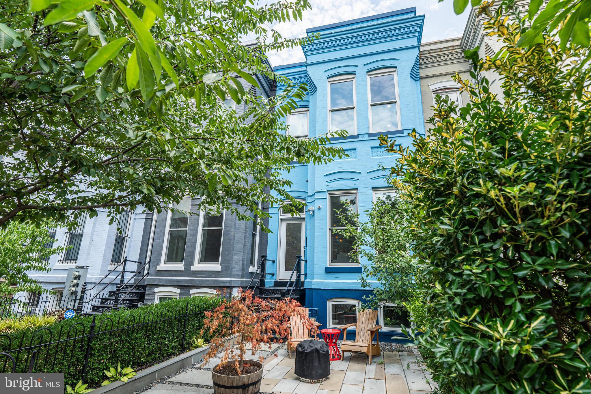 a front view of a house with plants