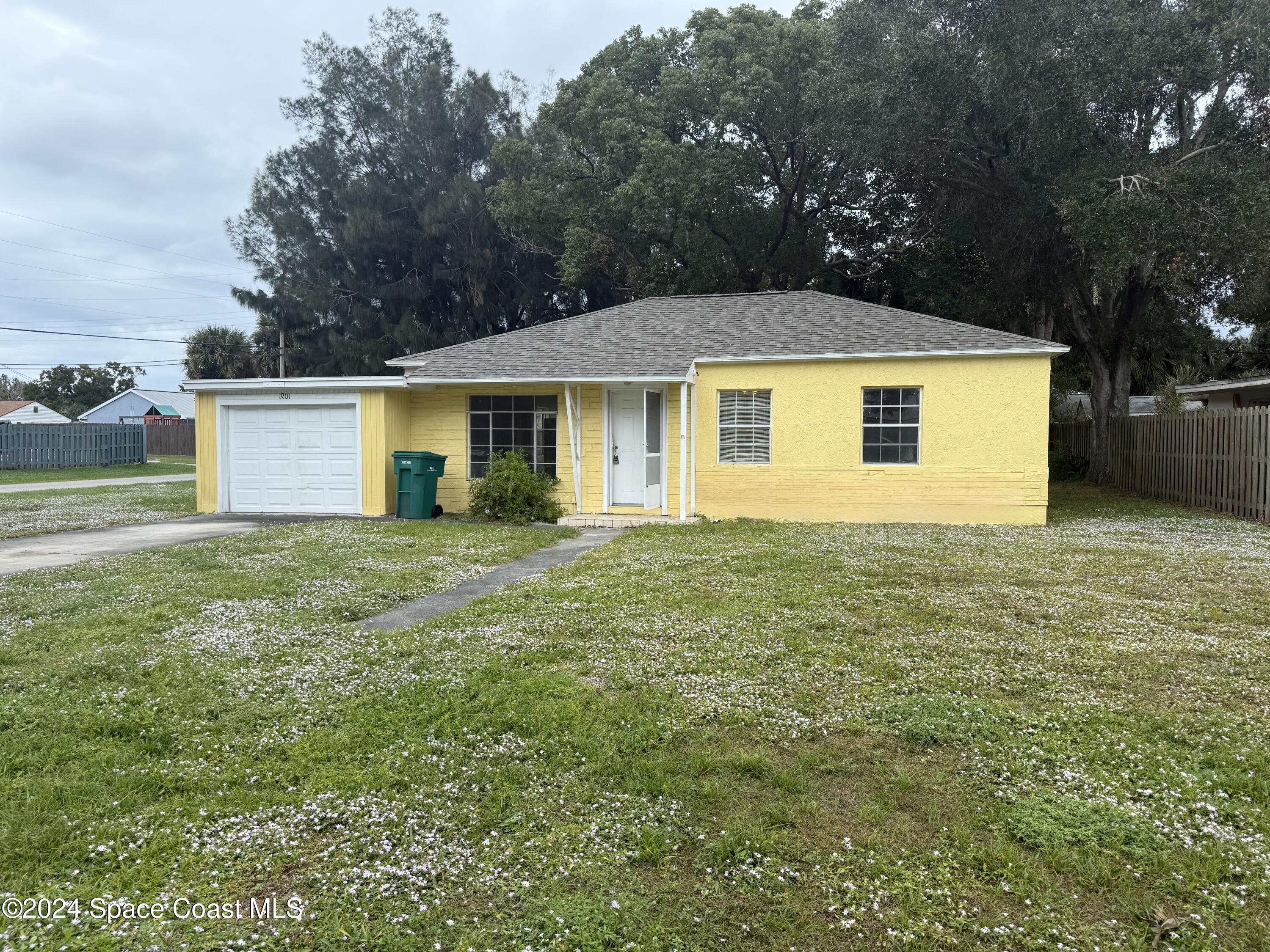 a front view of house with yard and trees