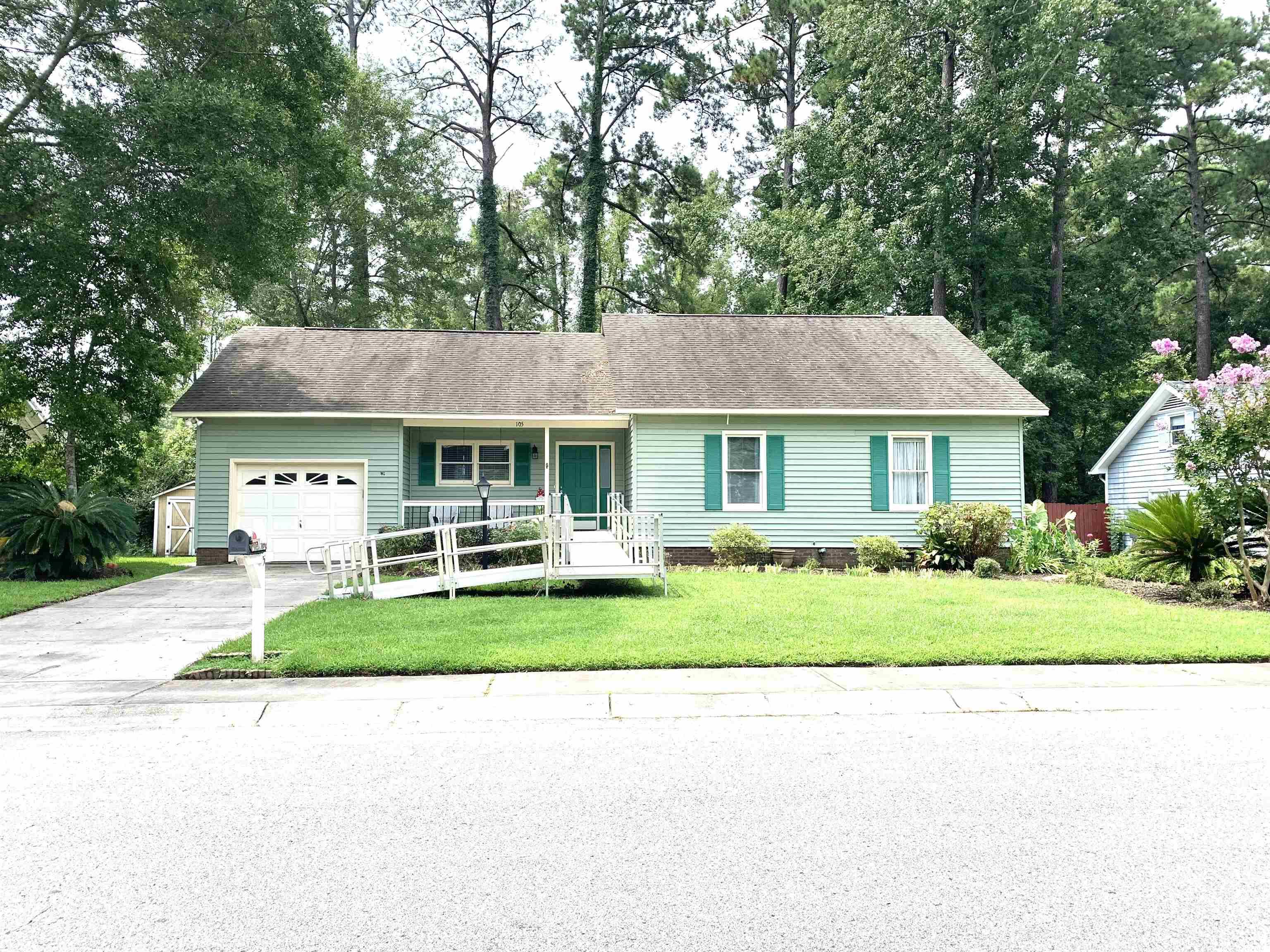 Ranch-style home with a garage and a front lawn