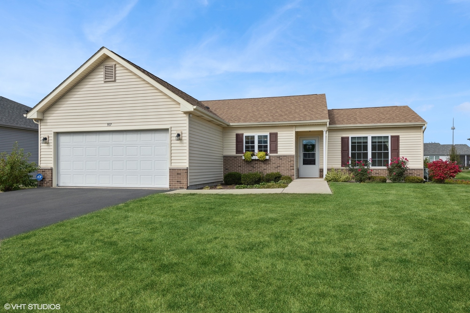 a front view of house with yard and green space