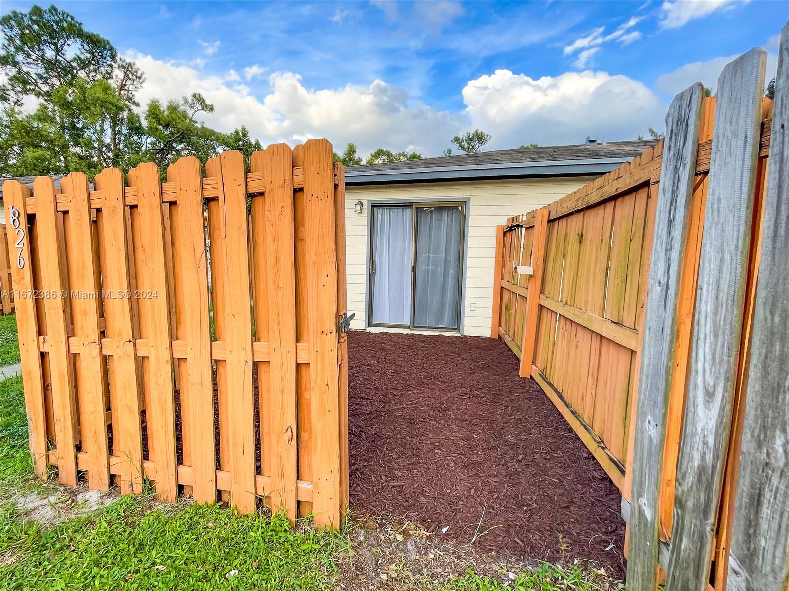 a view of a porch with wooden fence