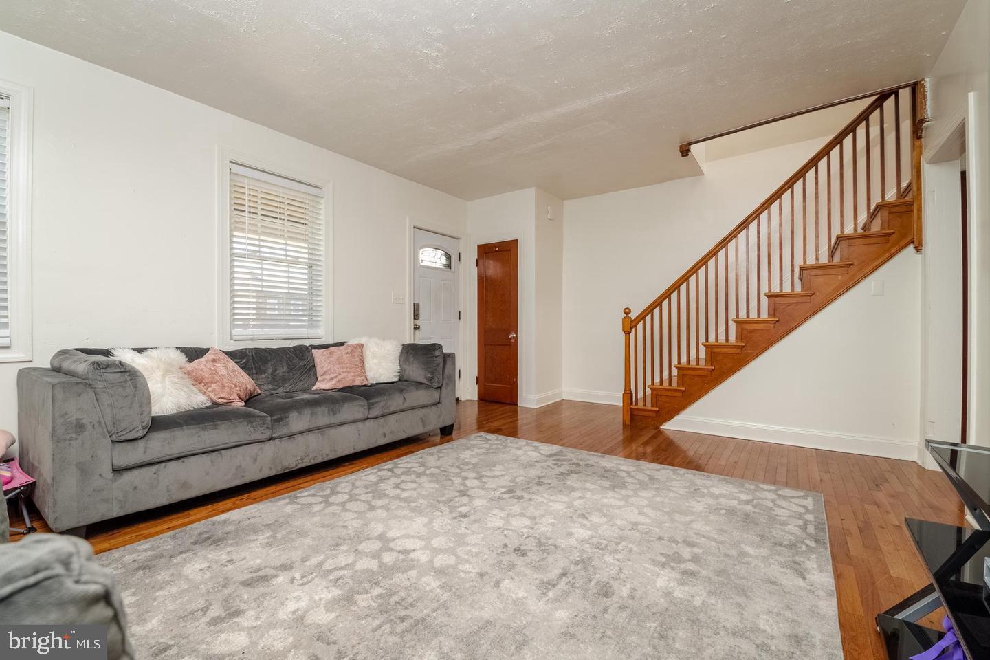 a living room with furniture and stairs