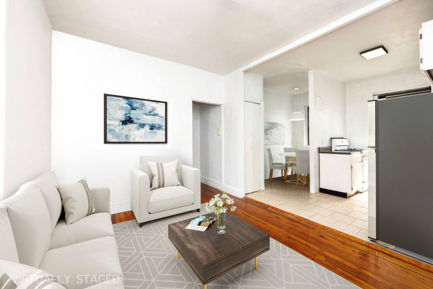 a living room with furniture and kitchen view