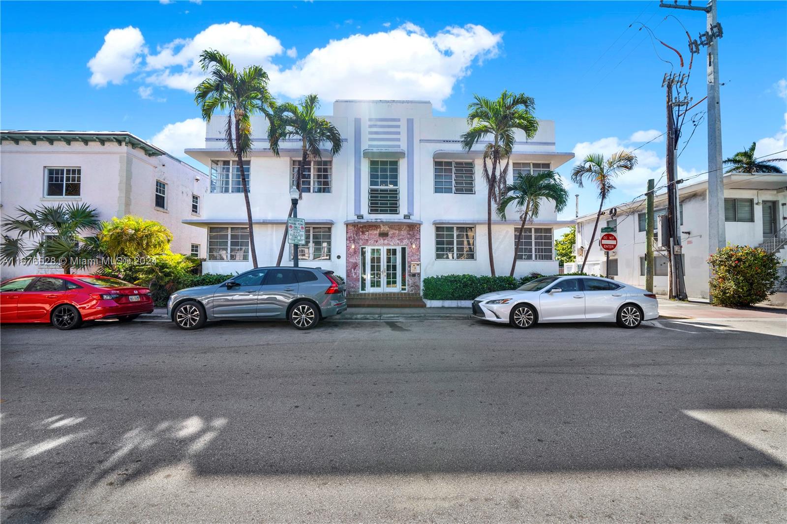 a view of a cars is parked in front of a building