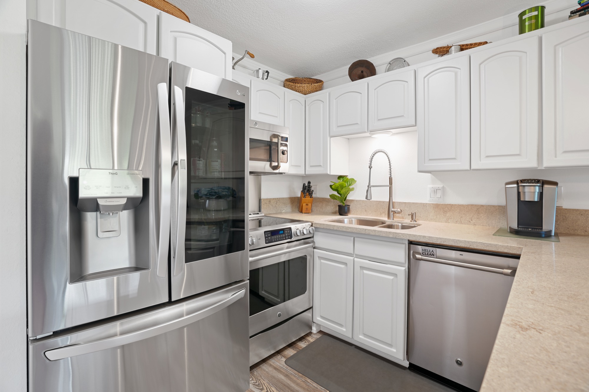 a kitchen with stainless steel appliances a refrigerator sink and cabinets