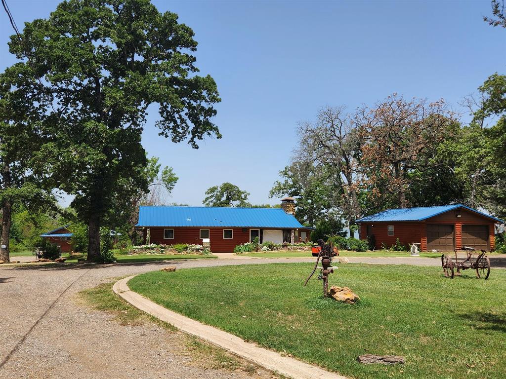 a view of an house with backyard space and deck