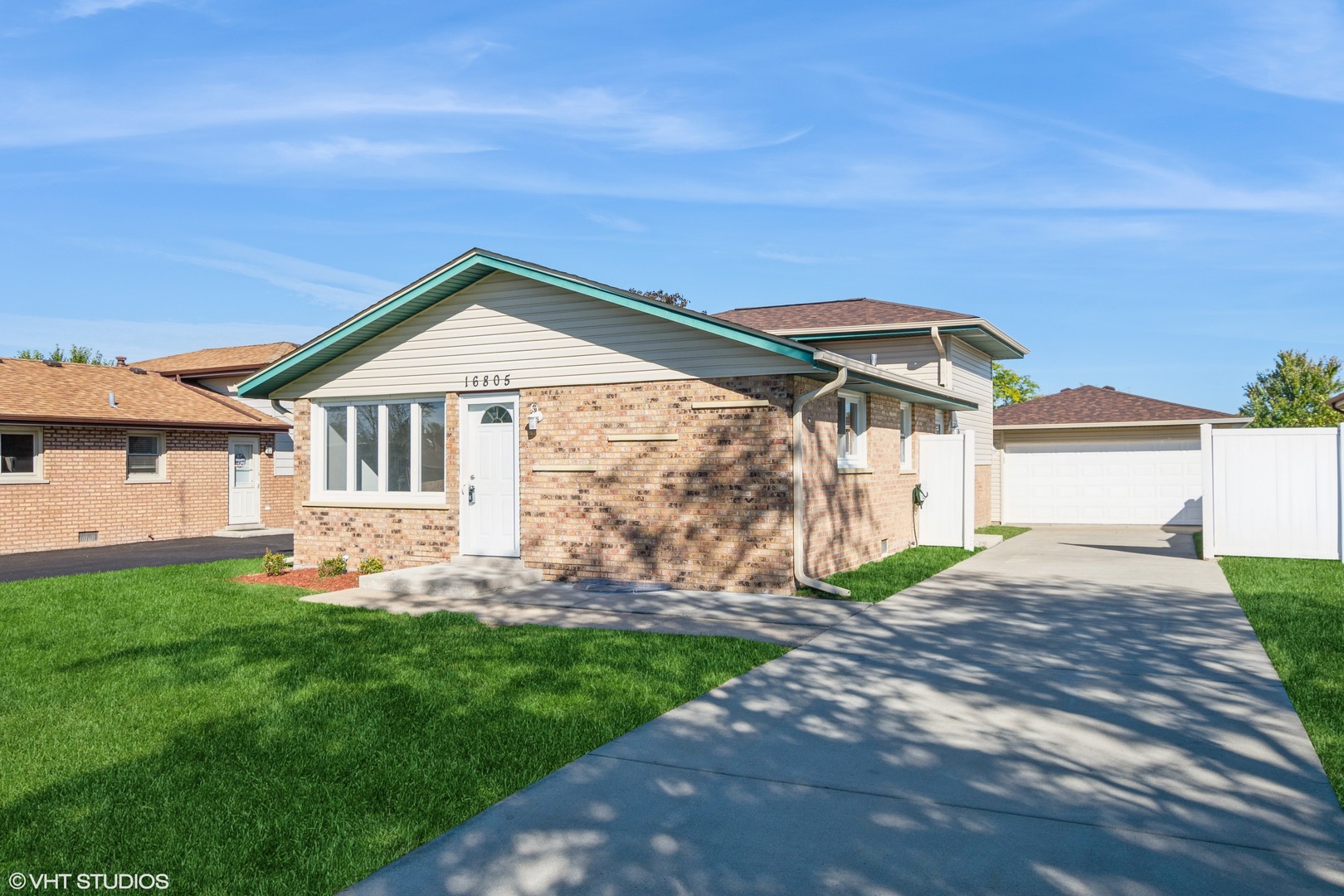 a front view of a house with a garden and yard