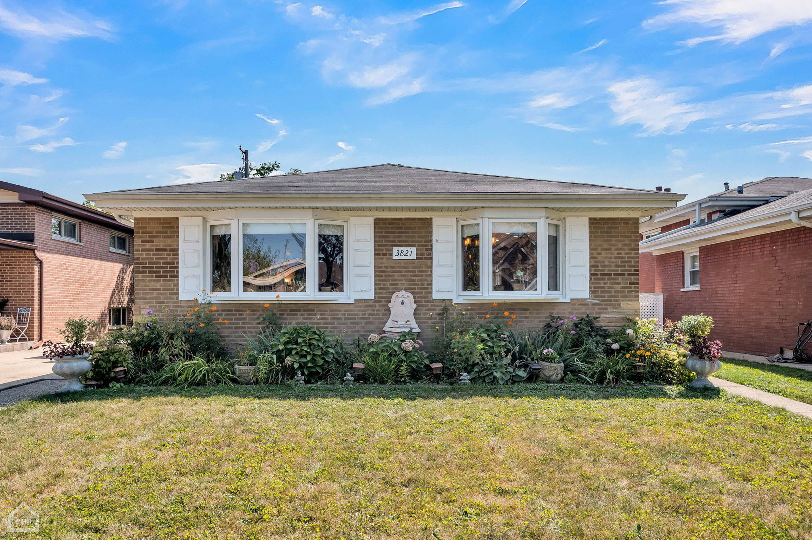 a front view of a house with garden