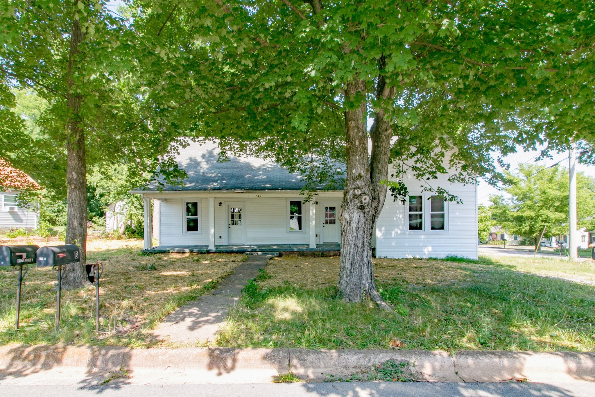 a house that has a tree in front of it