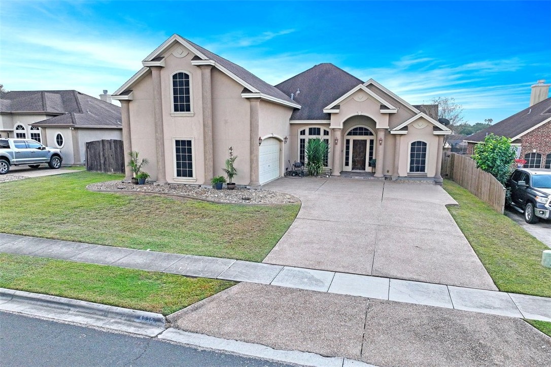 a front view of a house with a yard and garage