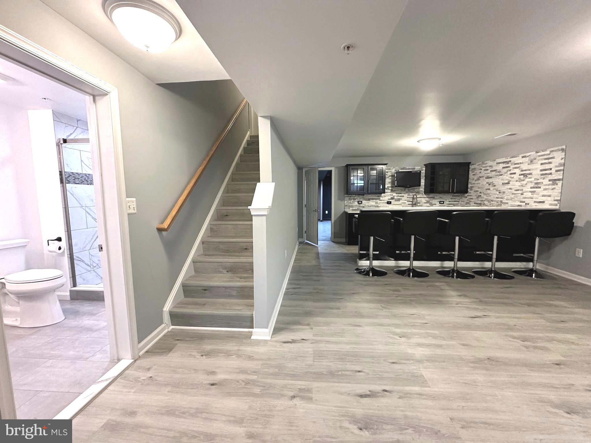 a view of a hallway and dining room with wooden floor