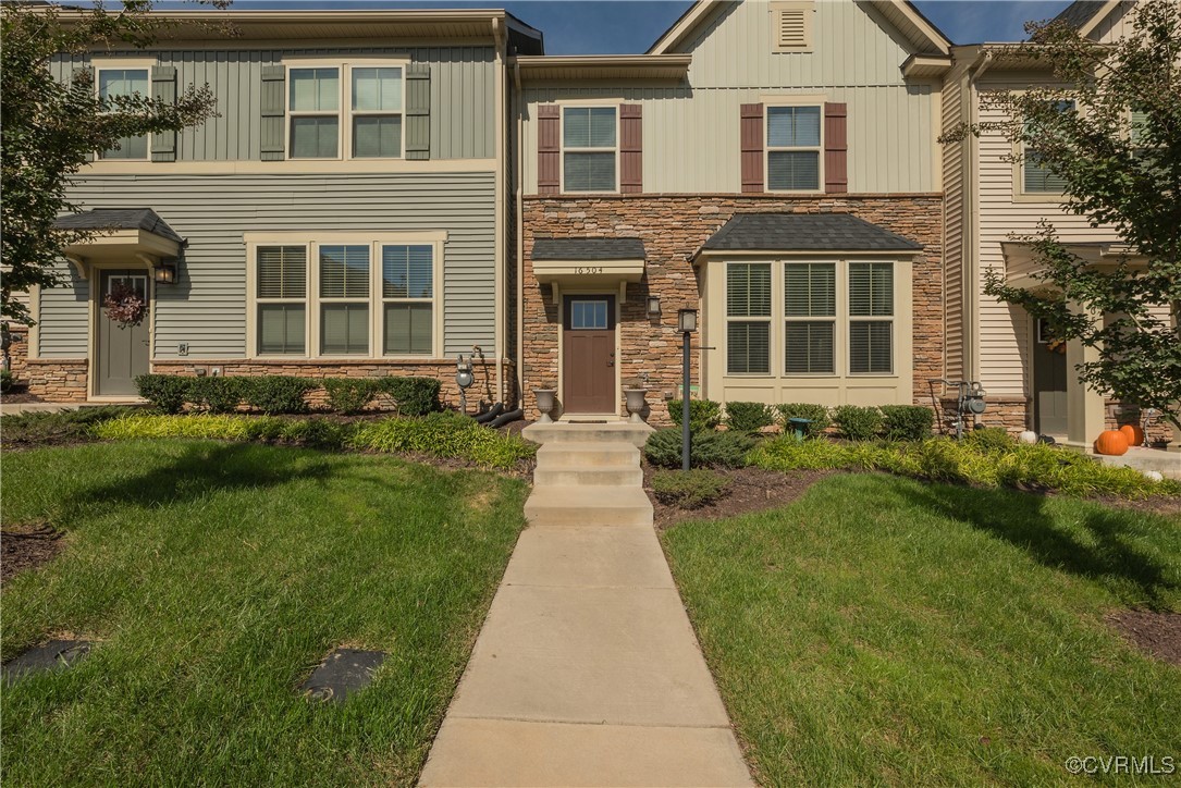 front view of a brick house with a yard