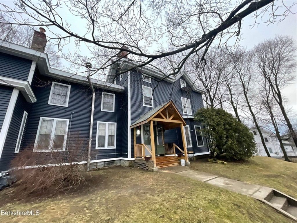 a view of a house with a snow on the road