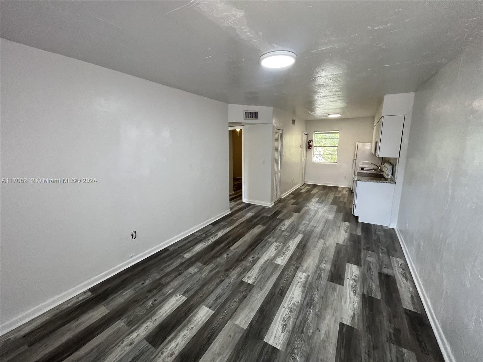 a view of a room with wooden floor