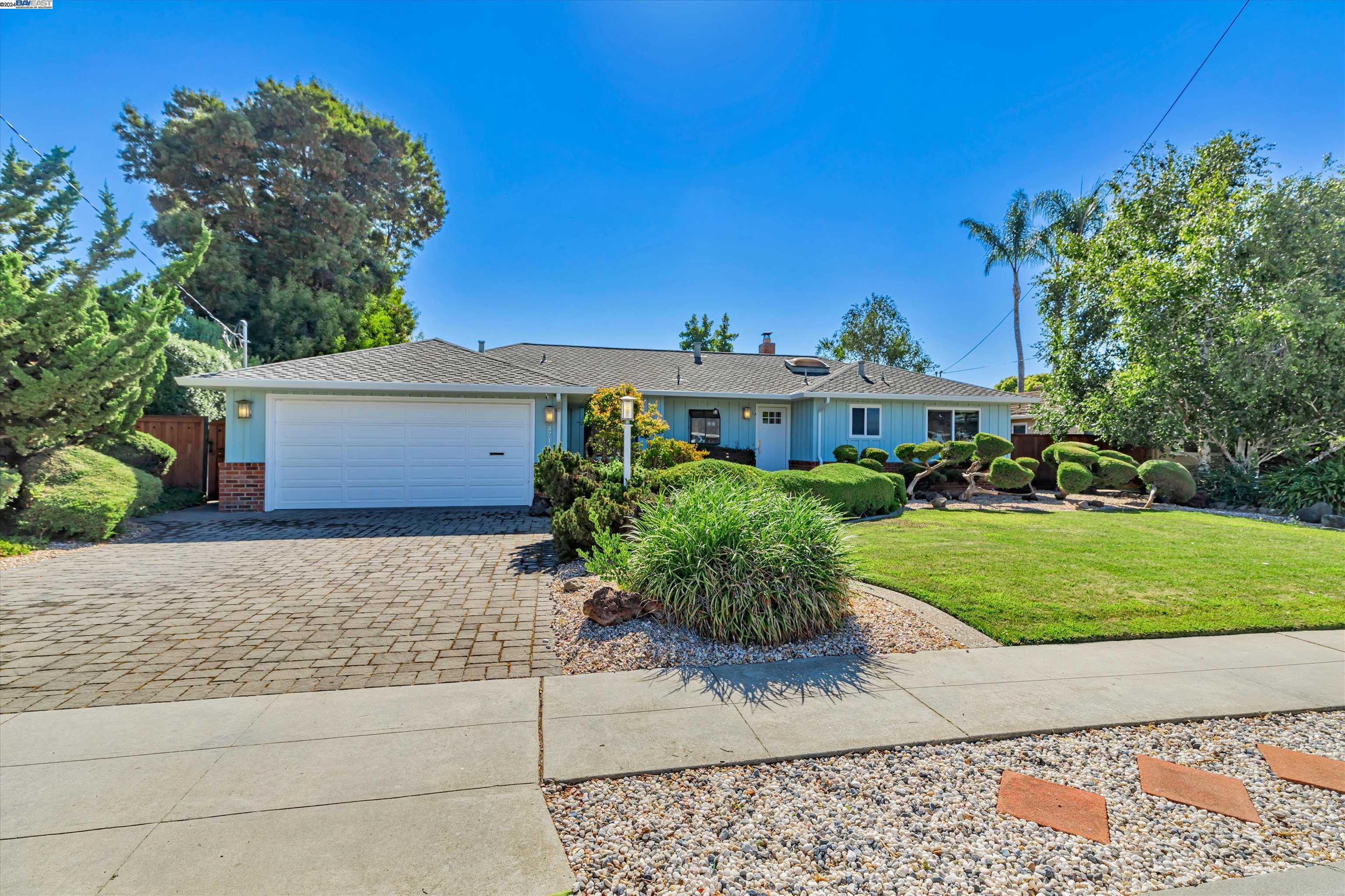 a front view of a house with a yard and a garage