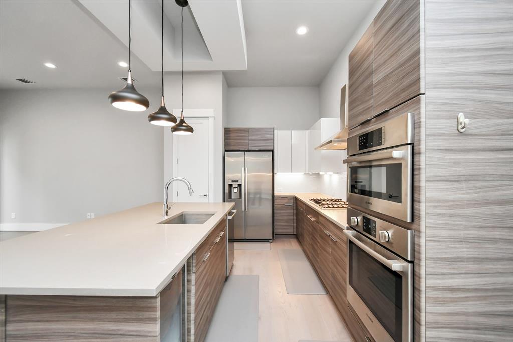 a kitchen with a sink and stainless steel appliances