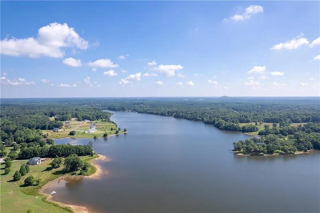 an aerial view of a houses with outdoor space and lake view