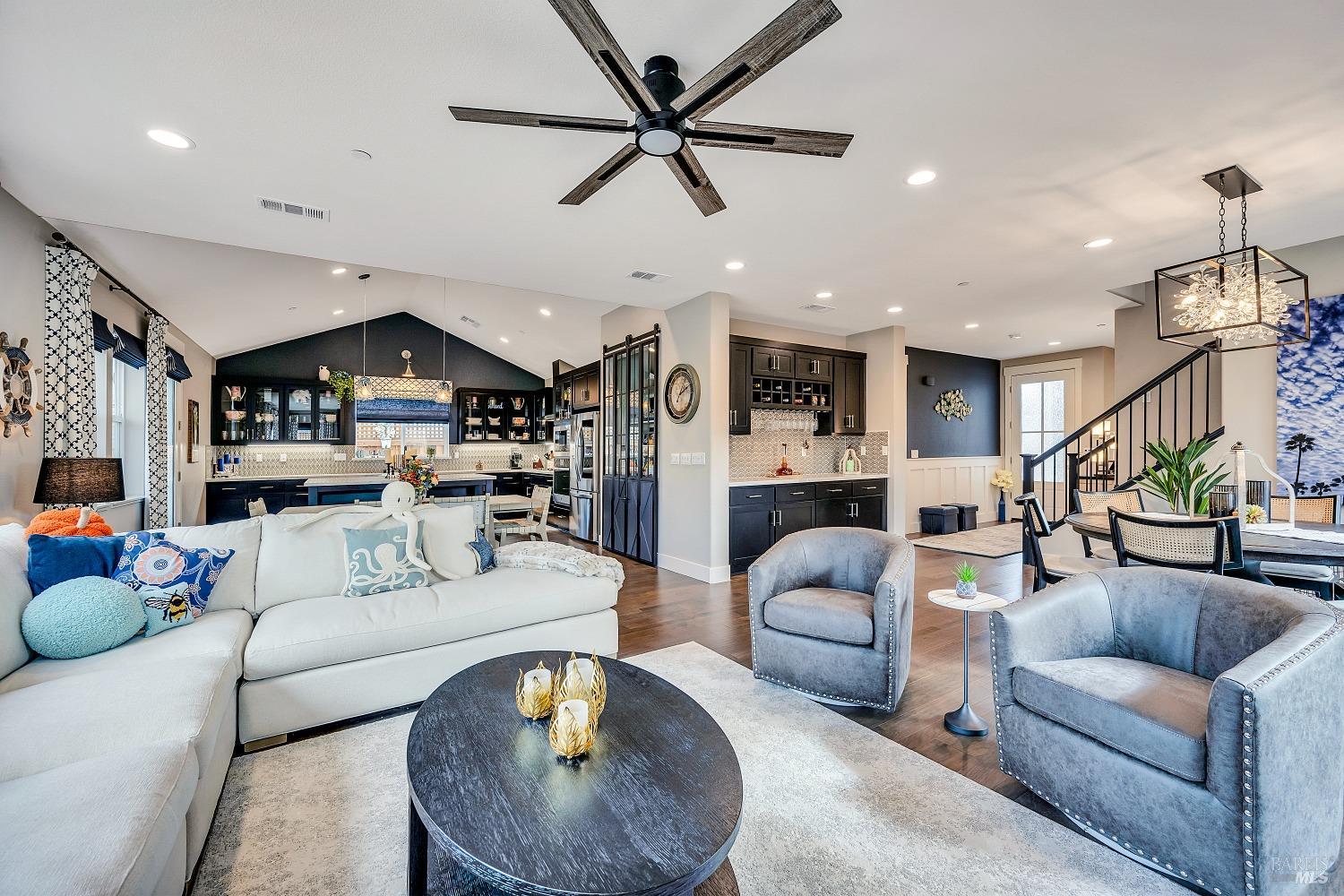 a living room with furniture and kitchen view