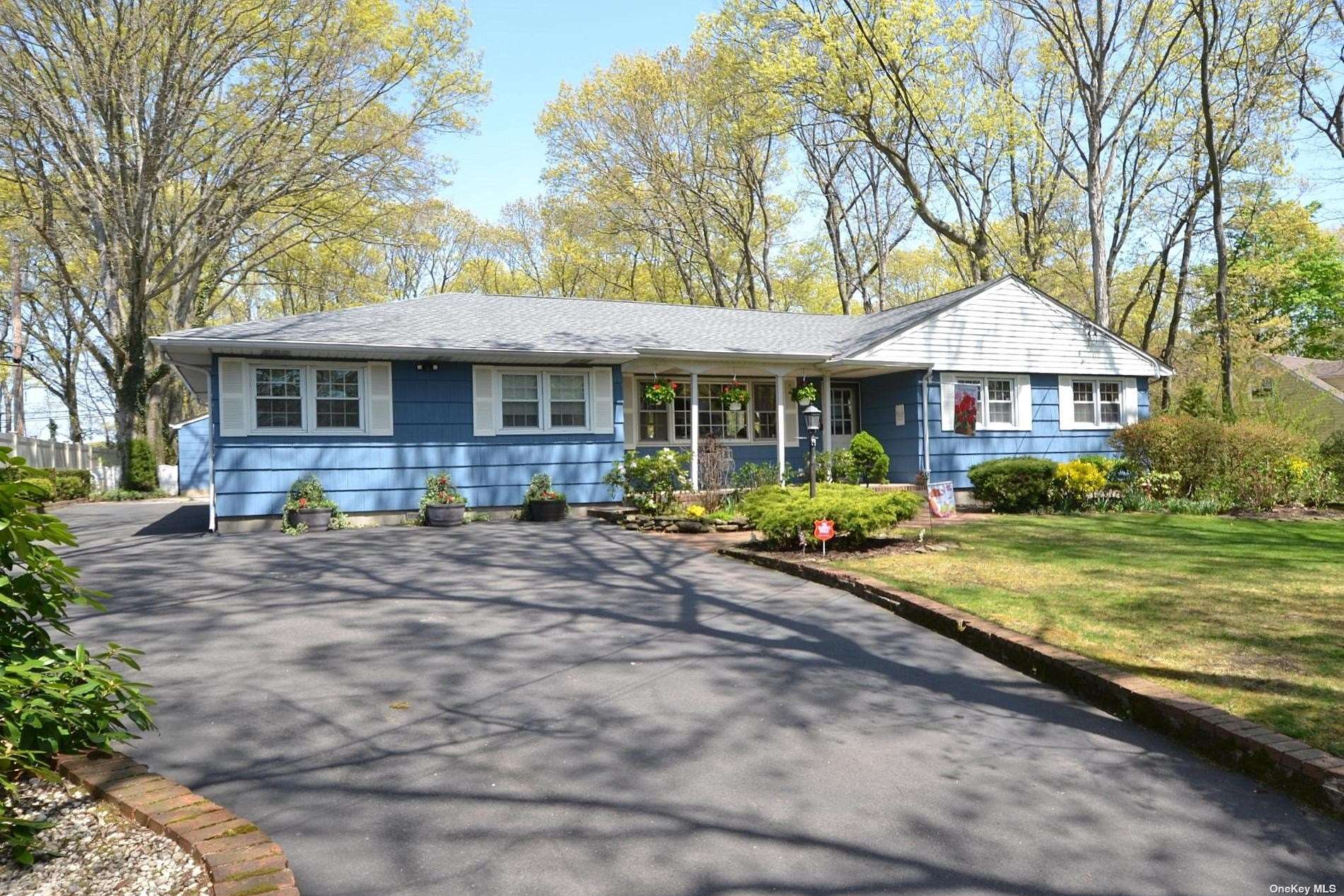 a front view of a house with garden and porch