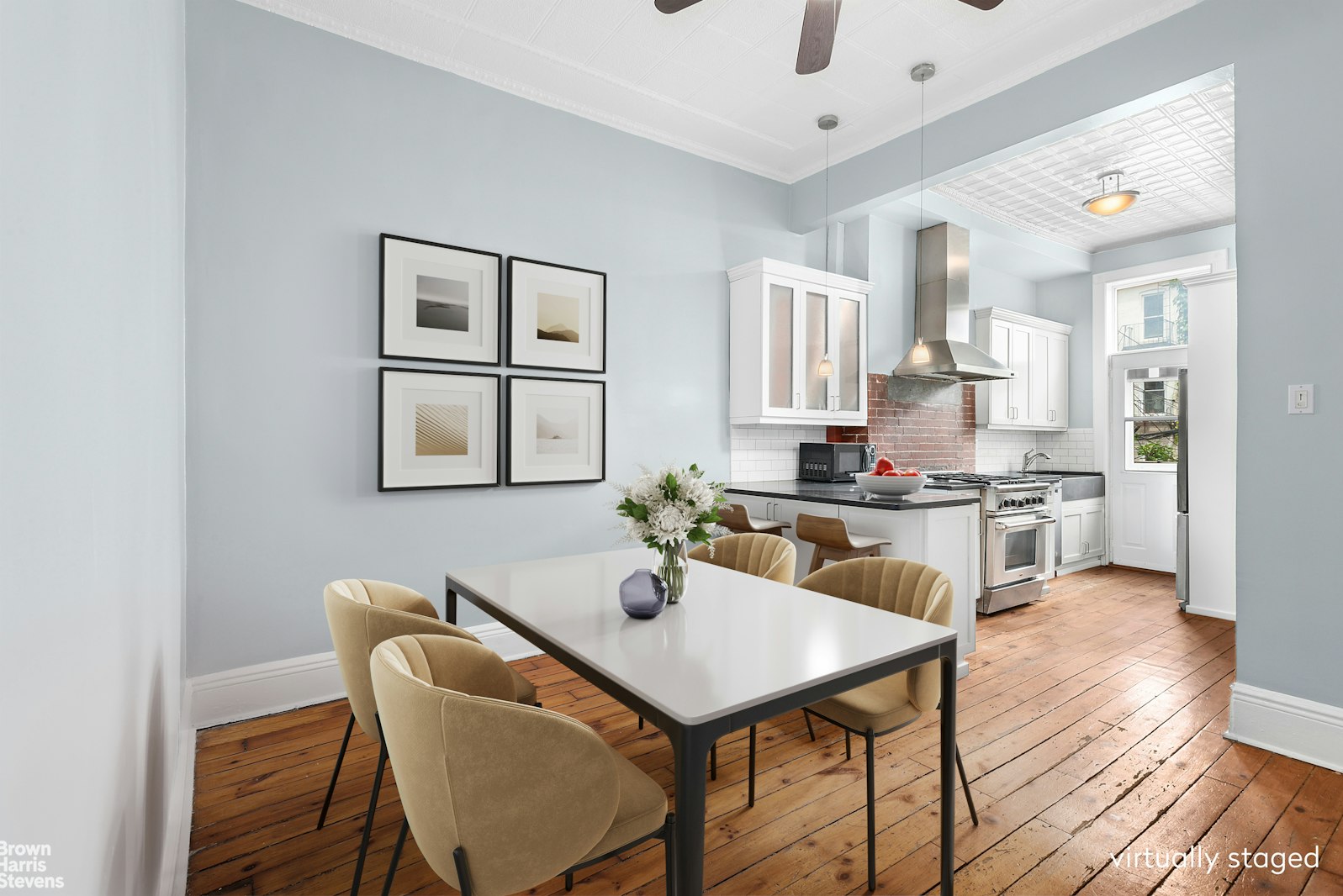 a kitchen with a dining table chairs and white cabinets