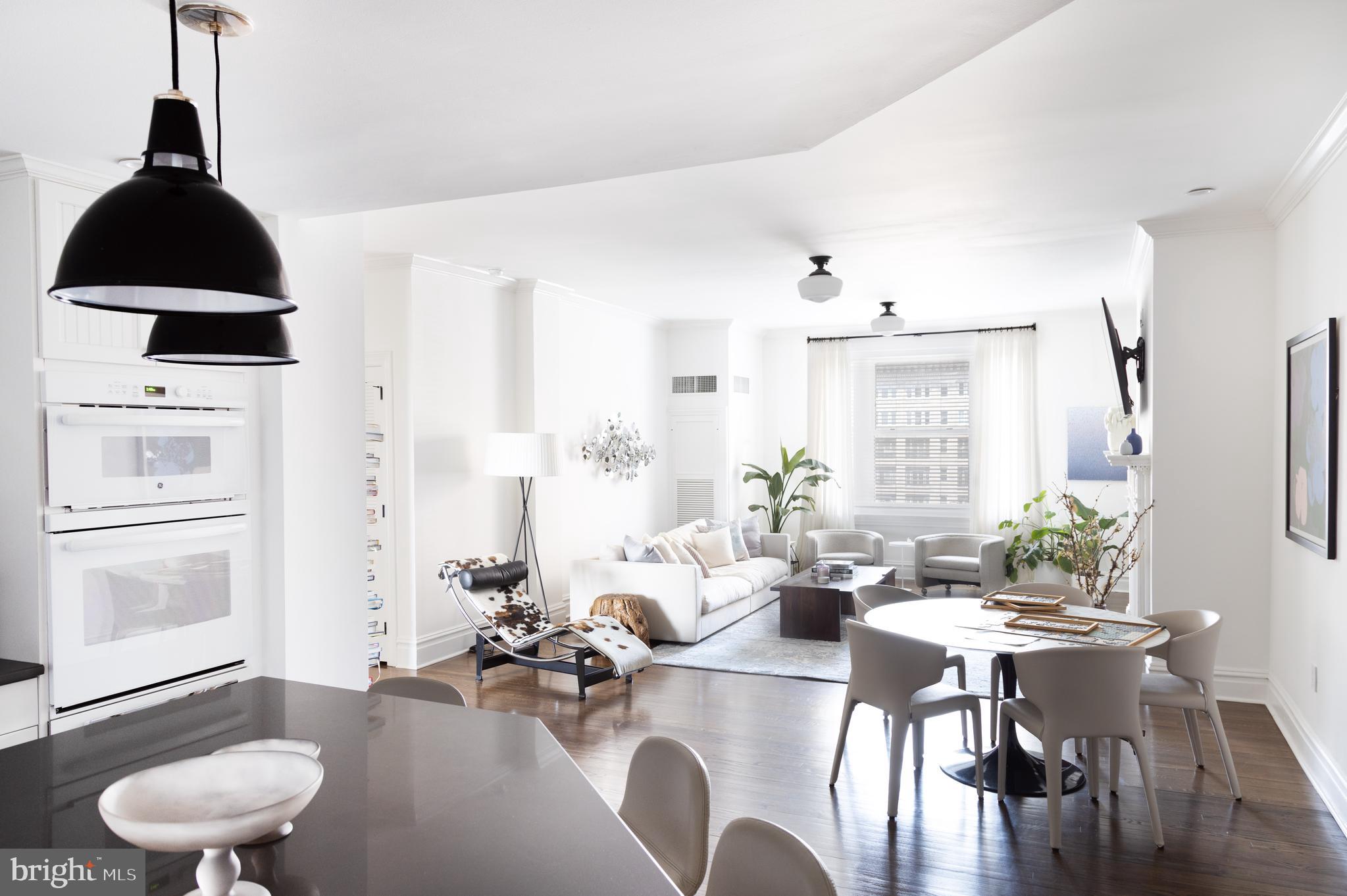 a dining room with furniture and wooden floor