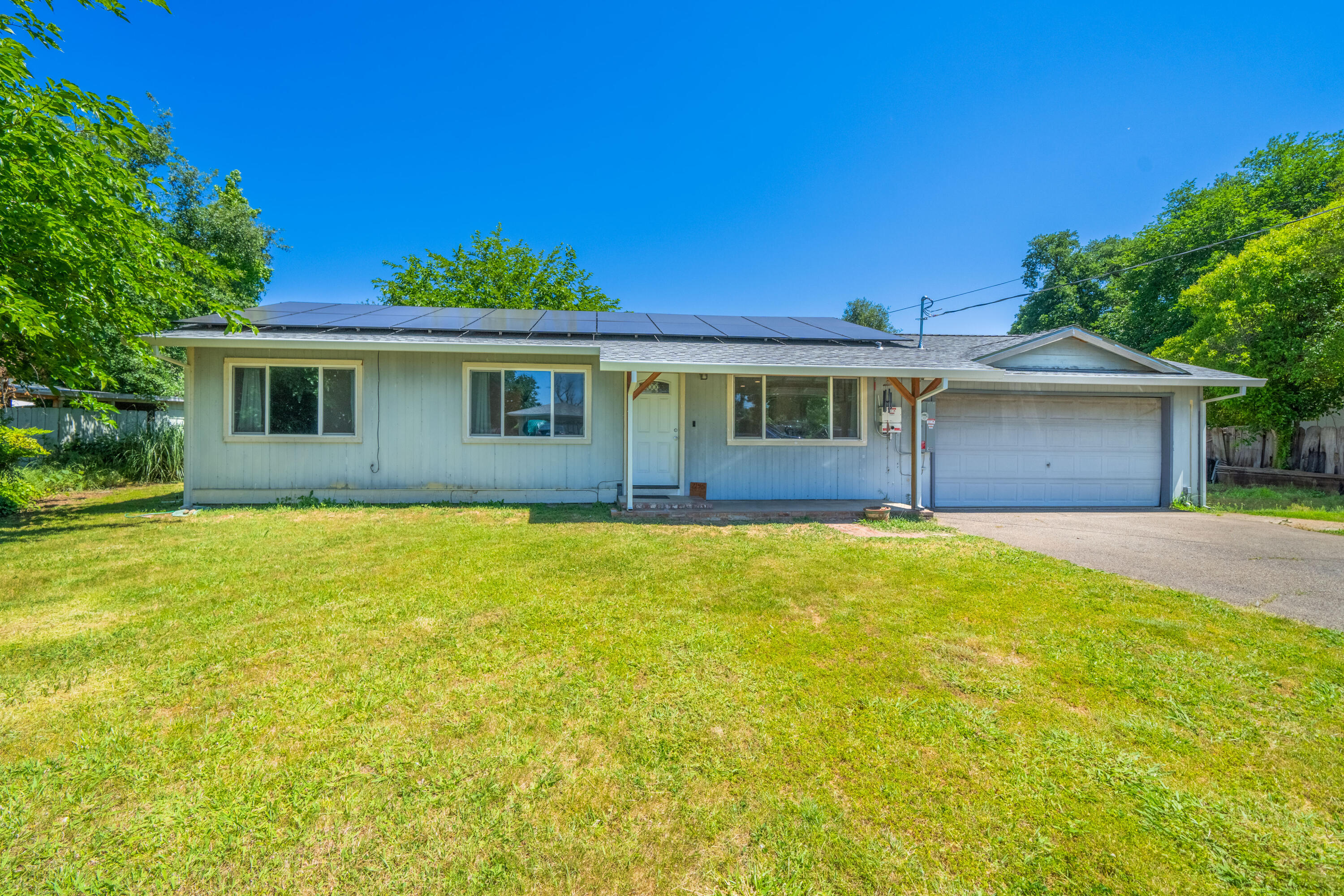 a front view of a house with yard and garage