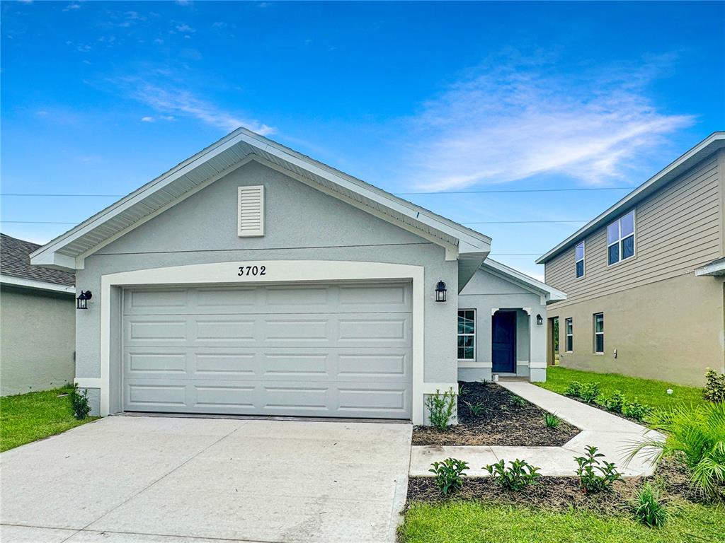 a front view of a house with garage