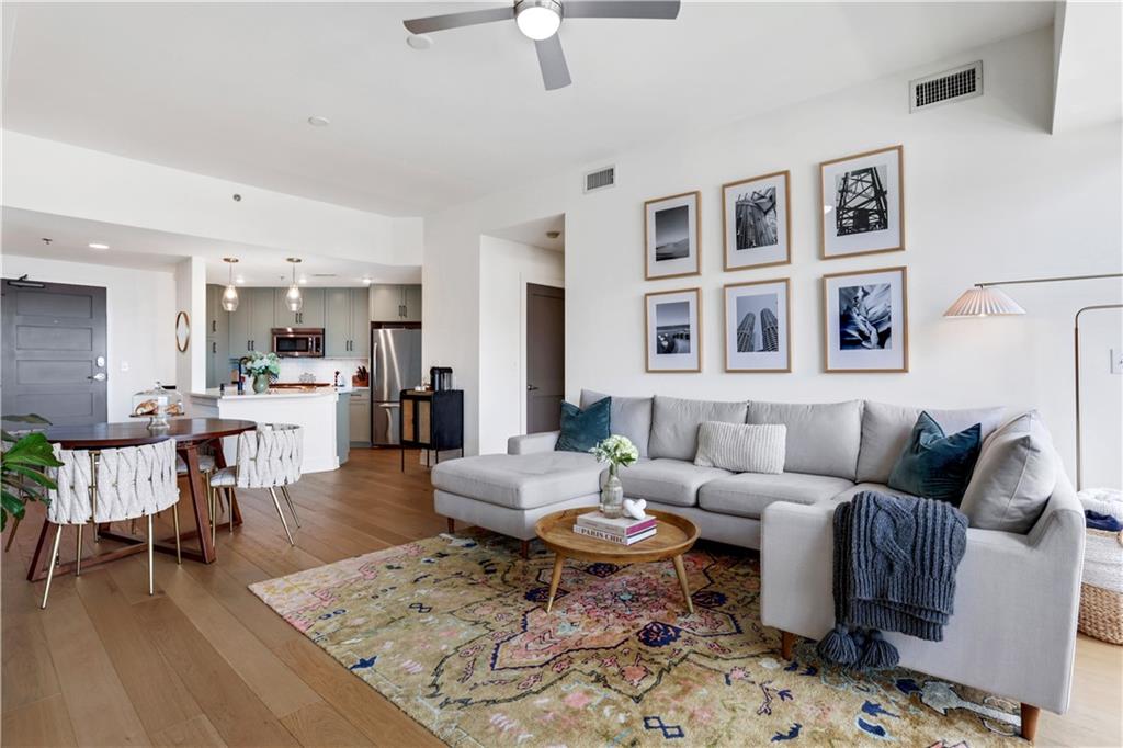 a living room with furniture and wooden floor