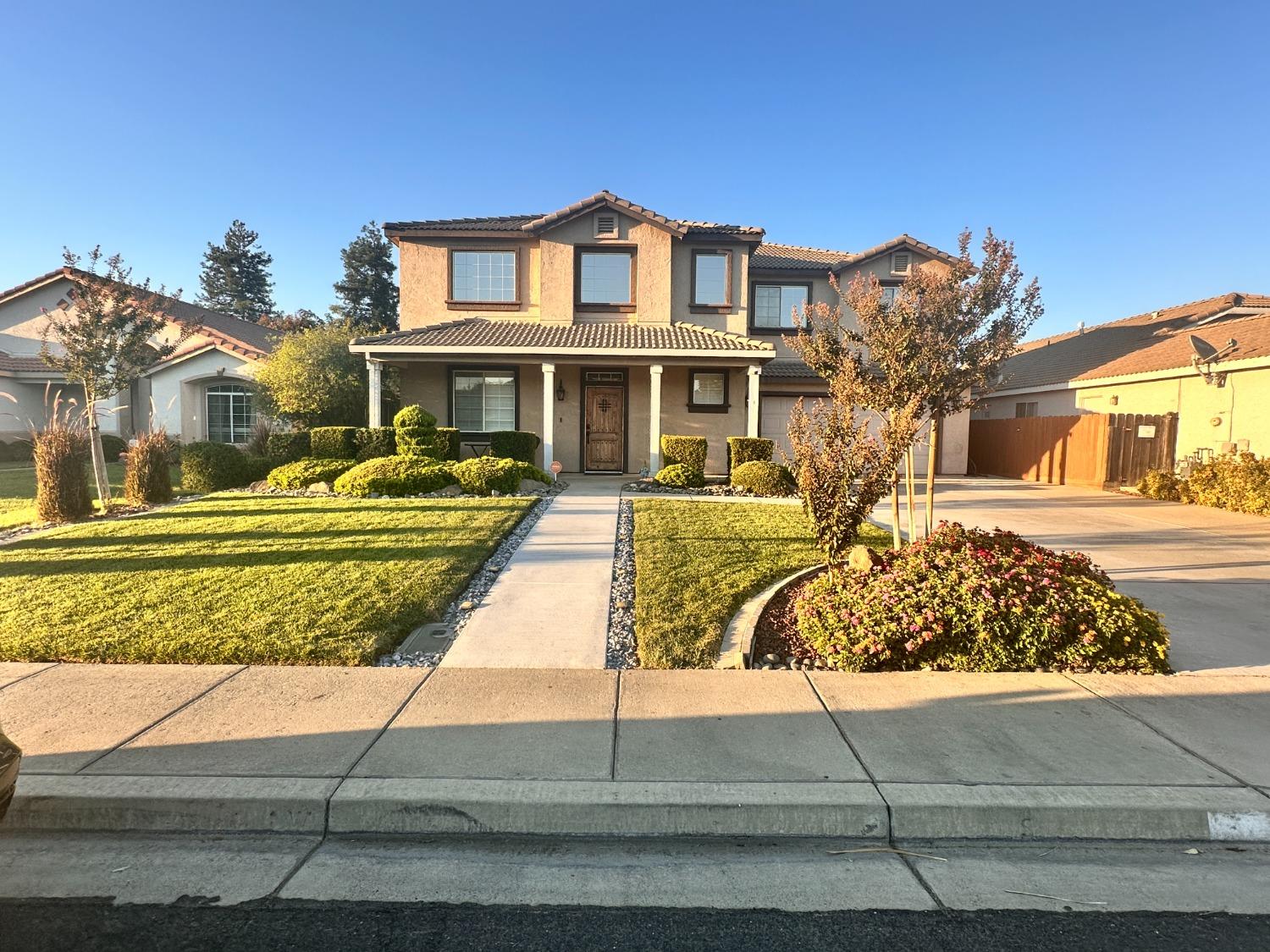 a front view of a house with a garden