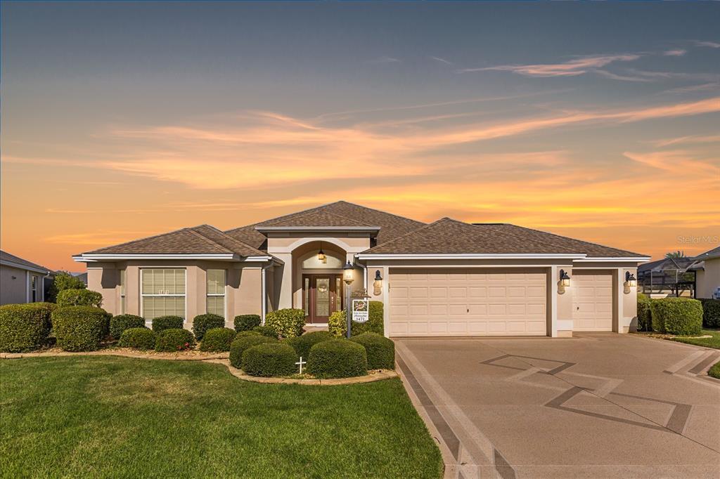 a front view of a house with a yard and garage