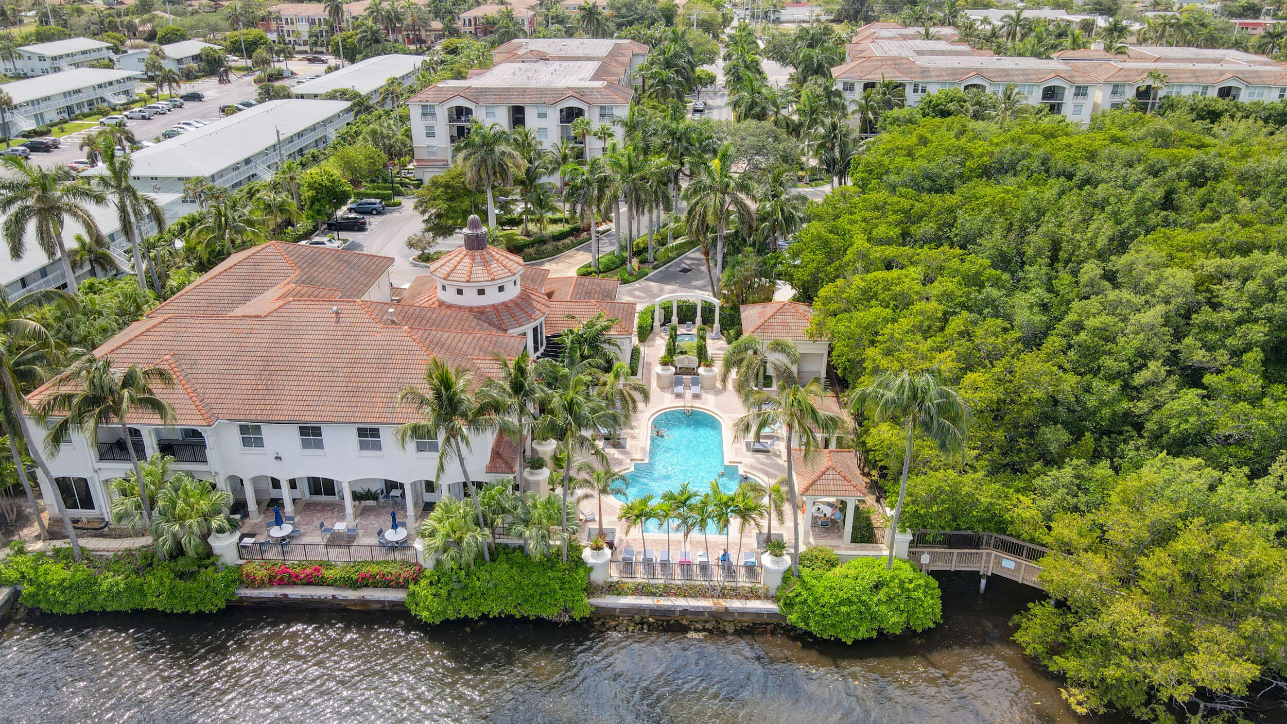 an aerial view of a house with a yard and lake view