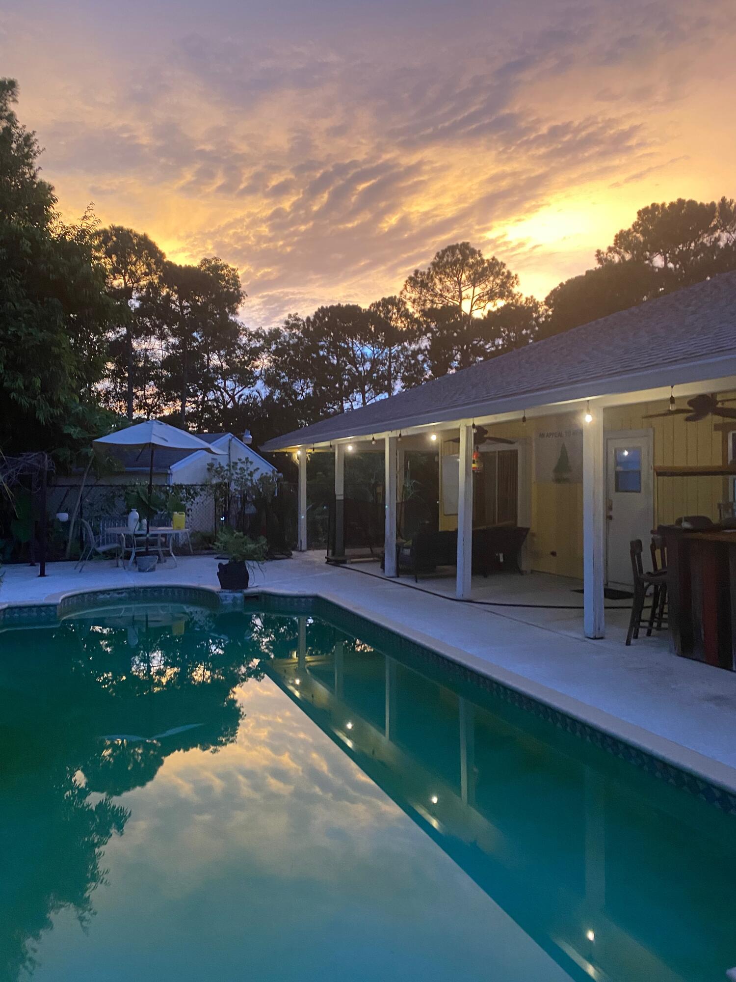 a view of an house with backyard space and balcony