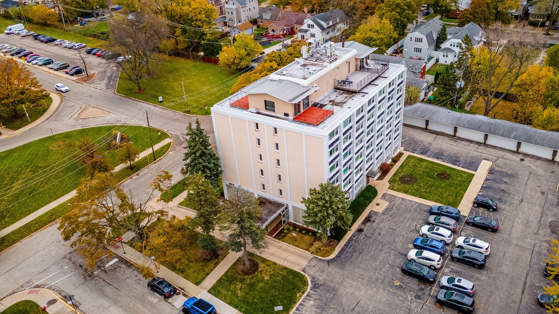 an aerial view of a house with a garden and parking space