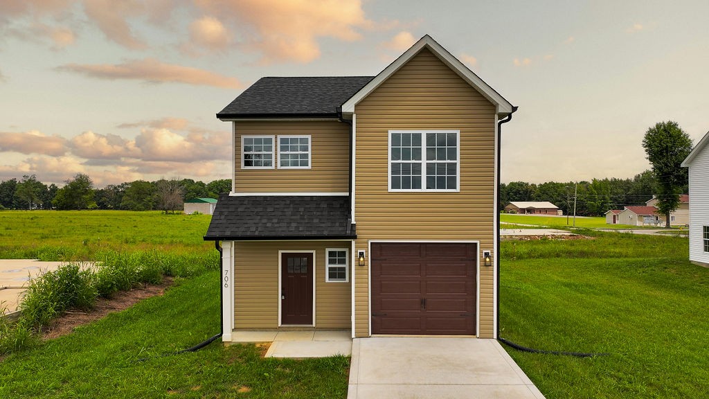 a front view of a house with a yard