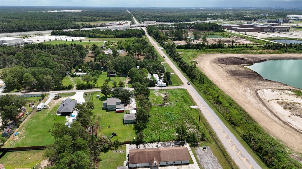 an aerial view of residential houses with outdoor space and river view