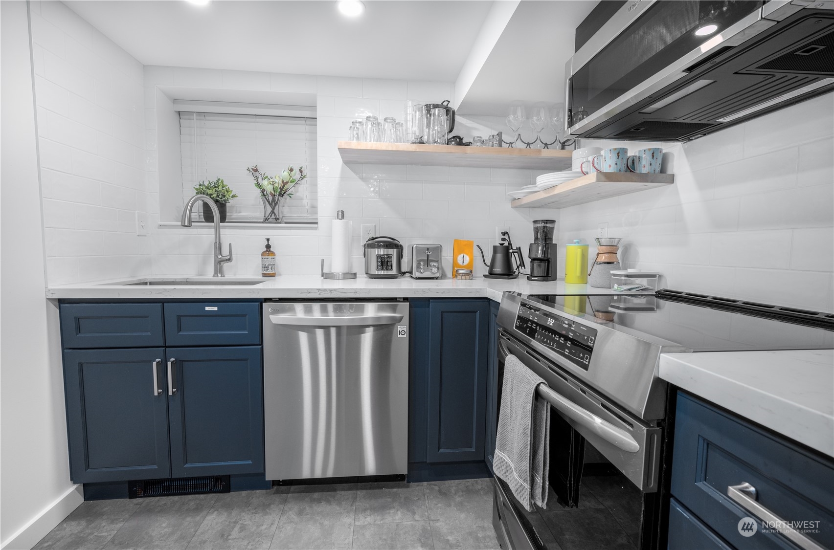 a kitchen with stainless steel appliances a sink and a stove