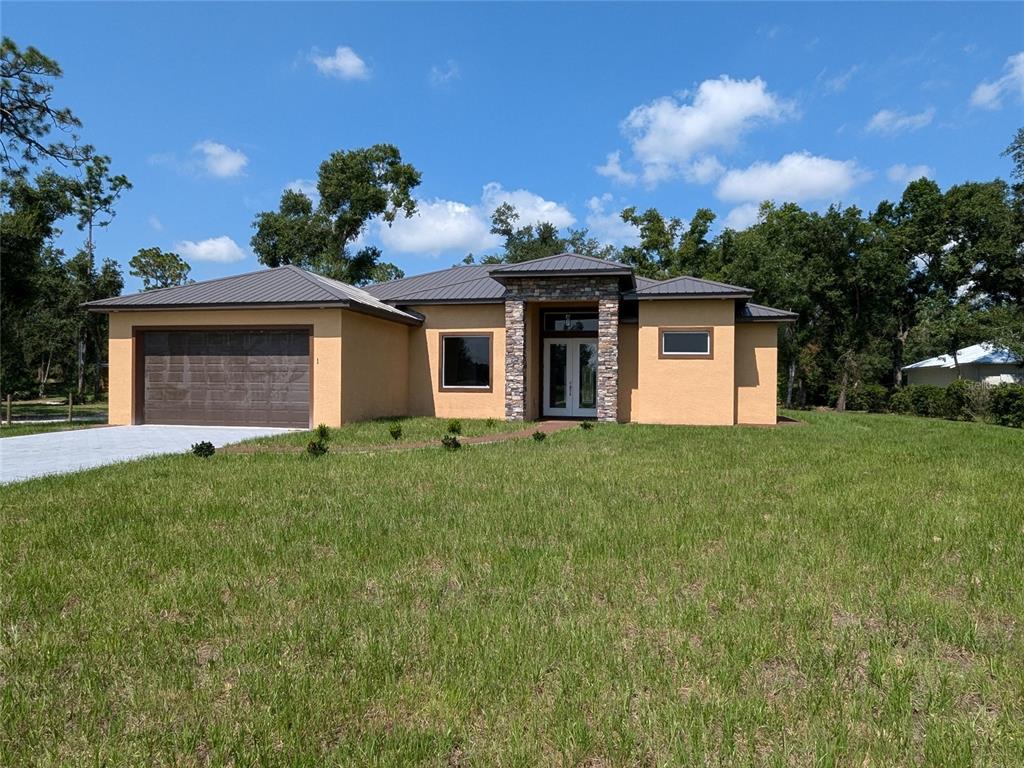 a front view of house with yard and trees