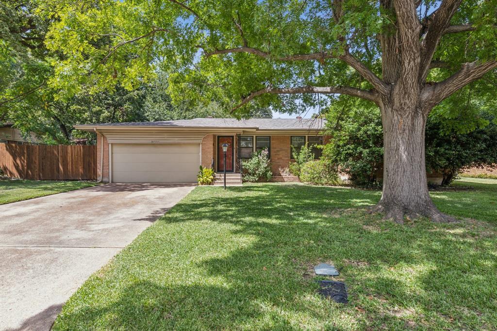 a front view of house with yard and trees