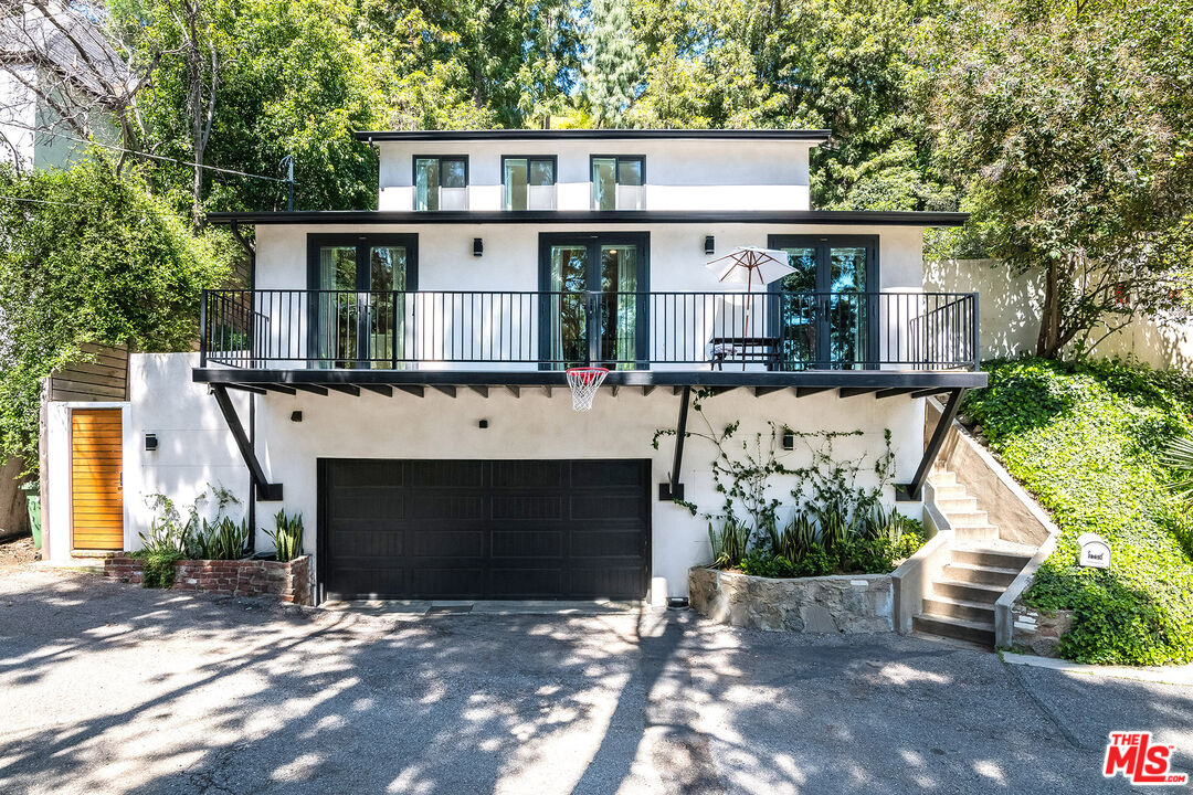 a front view of a house with a yard and a garage