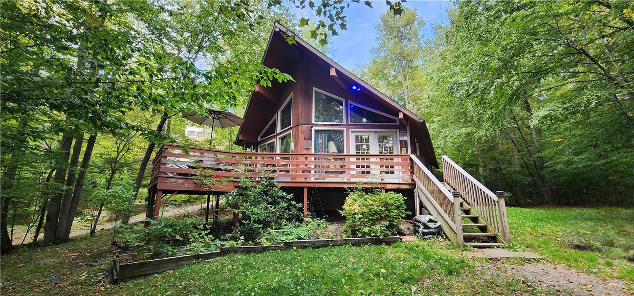 Rear view of house featuring a wooden deck