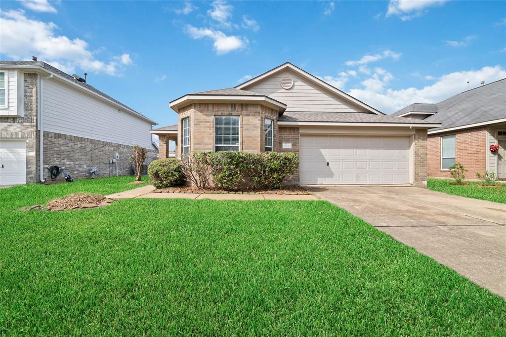 a front view of a house with a yard and garage