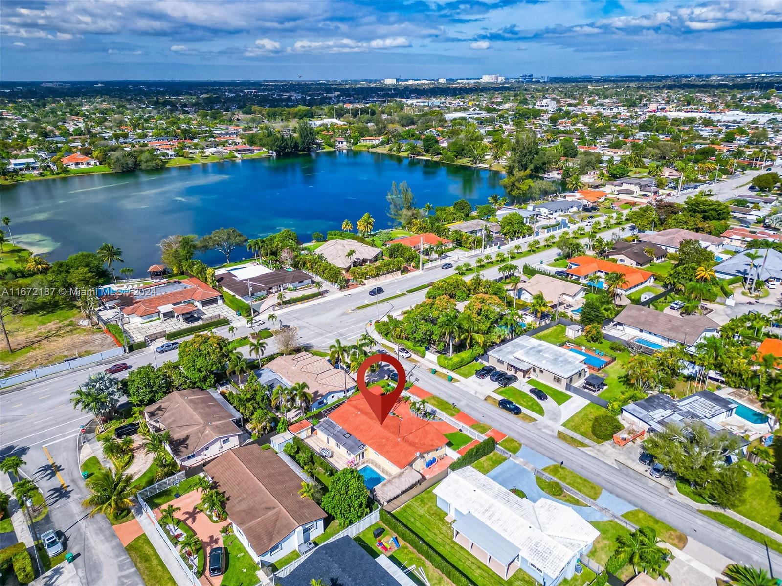 an aerial view of residential houses with outdoor space and swimming pool